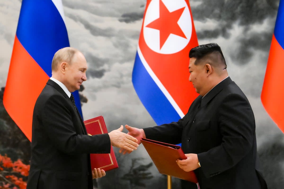 Russian President Vladimir Putin (left) and North Korean leader Kim Jong-un exchange documents during a ceremony for their new partnership in Pyongyang, North Korea, in June (Sputnik)