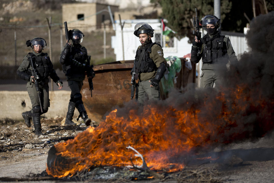 Israeli troops take their position during clashes with Palestinian demonstrators as they protest Middle East peace plan announced Tuesday by US President Donald Trump, which strongly favors Israel, at Beit El checkpoint, near the West Bank city of Ramallah, Wednesday, Jan 29, 2020 (AP Photo/Majdi Mohammed)