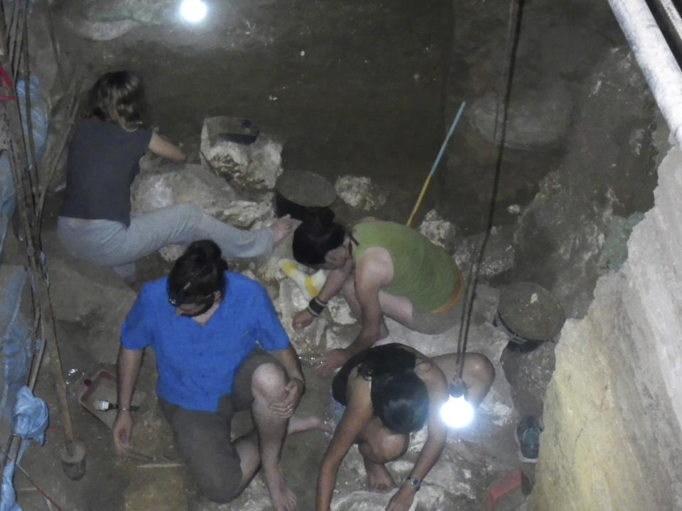In this June 30, 2015, handout photo provided by Eusebio Dizon, foreign and Filipino archeologists work inside Callao cave in Cagayan province, northern Philippines where they recovered fossil bones and teeth belonging to a new human species they called Homo Luzonensis. Archaeologists who discovered fossil bones and teeth of a previously unknown human species that thrived more than 50,000 years ago in the northern Philippines say they plan more diggings and better protection of the popular limestone cave complex where the remains were unearthed. (Eusebio Dizon via AP)