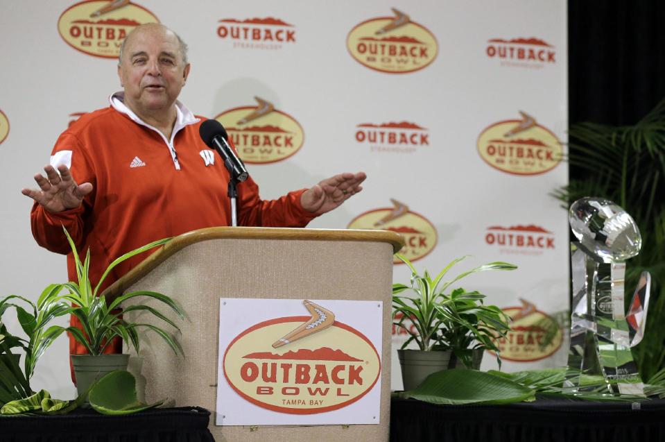 Wisconsin’s Barry Alvarez laughs as he stands near the Outback Bowl winner’s trophy during a news conference on Jan. 1, 2015. (AP)