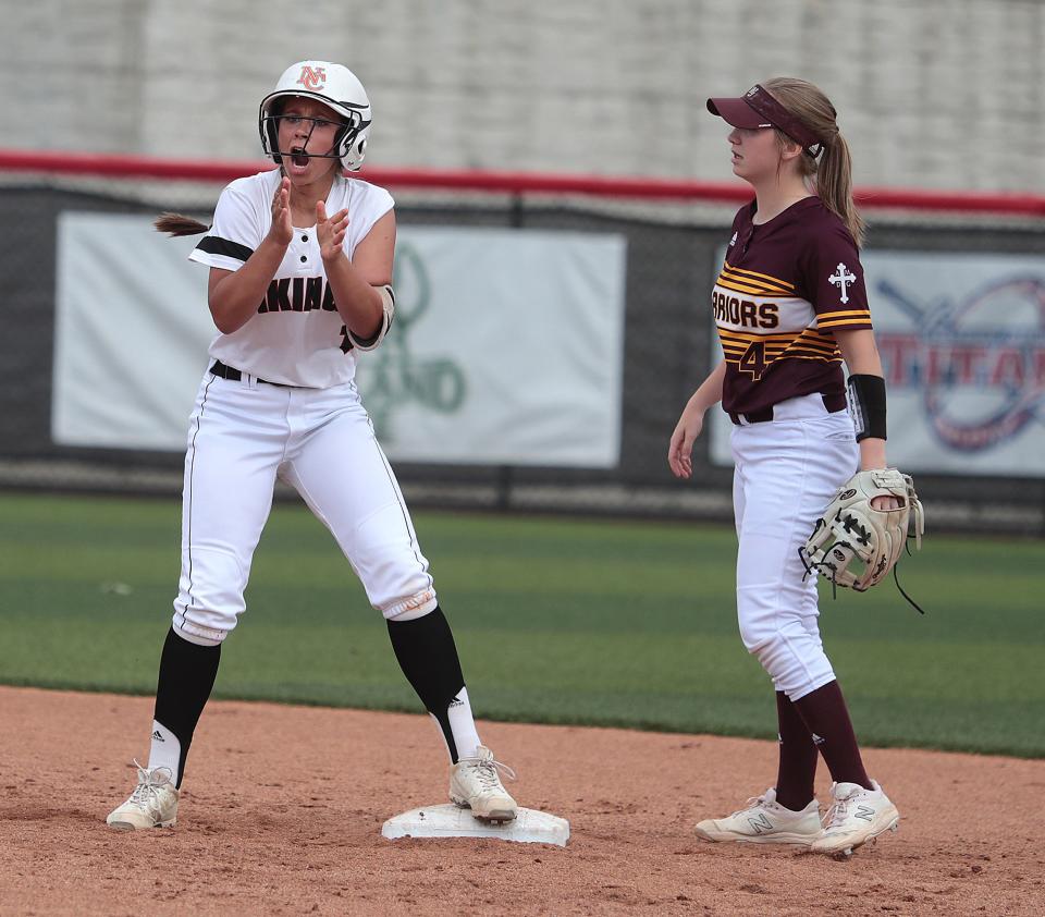 Sienna Koosh of Hoover celebrates after a double in the third inning as Walsh Jesuit shortstop McKayla McGee looks on during their Division I regional semifinal at Youngstown State University.