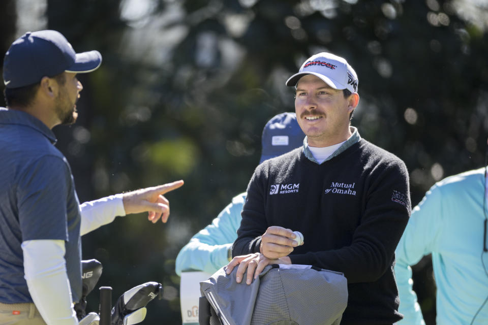 Joel Dahmen, right, listens to Jason Day, left, of Australia, while waiting on the third tee during the second round of the RSM Classic golf tournament, Friday, Nov. 18, 2022, in St. Simons Island, Ga. (AP Photo/Stephen B. Morton)