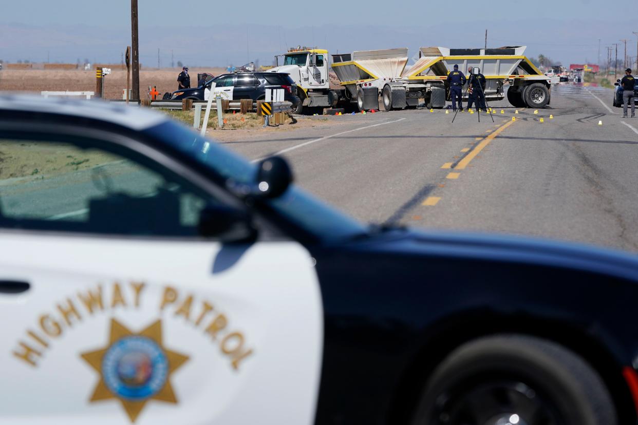 Law enforcement officers work at the scene of a deadly crash in Holtville, Calif., on Tuesday.