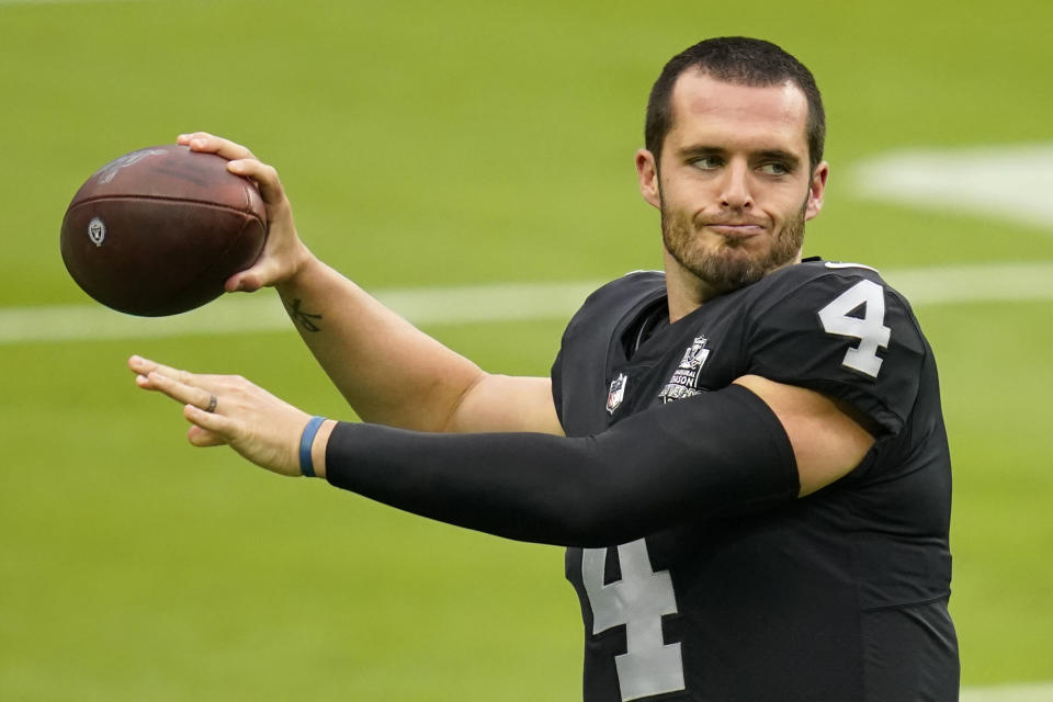 Las Vegas Raiders quarterback Derek Carr (4) throws a pass during an NFL football training camp practice Friday, Aug. 28, 2020, in Las Vegas. (AP Photo/John Locher)