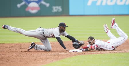 Jun 24, 2018; Cleveland, OH, USA; Cleveland Indians designated hitter Edwin Encarnacion (10) slides into second base for a double before the tag of Detroit Tigers second baseman Niko Goodrum (28) during the first inning at Progressive Field. Mandatory Credit: Ken Blaze-USA TODAY Sports