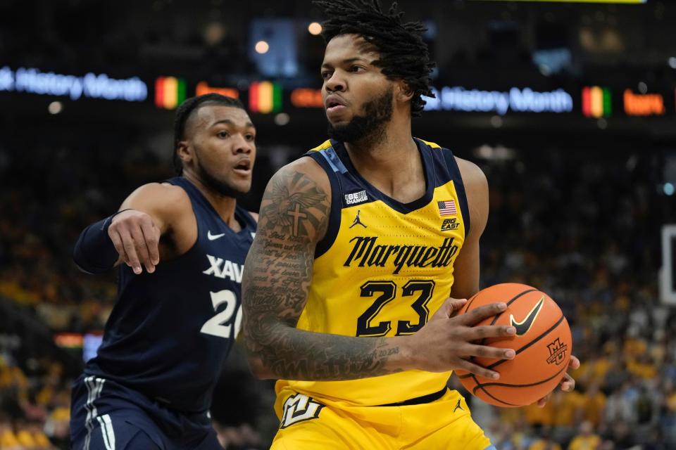 Marquette's David Joplin tries to get past Xavier's Dayvion McKnight during the first half of an NCAA college basketball game Sunday, Feb. 25, 2024, in Milwaukee.