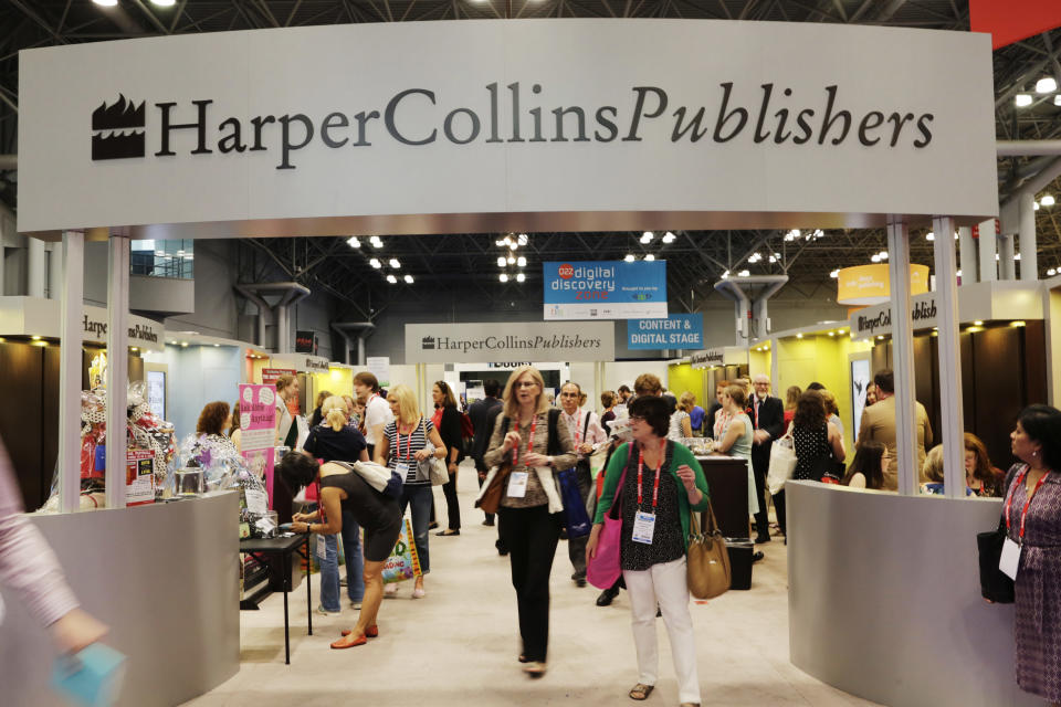 FILE - In this May 28, 2015 file photo, attendees at BookExpo America visit the HarperCollins Publishers booth in New York. The annual publishing convention and trade show, a decades-old tradition, may be coming to an end. ReedPop, which has managed BookExpo for a quarter century, announced Tuesday that it was dropping the event, along with the fan-based BookCon. (AP Photo/Mark Lennihan, File)