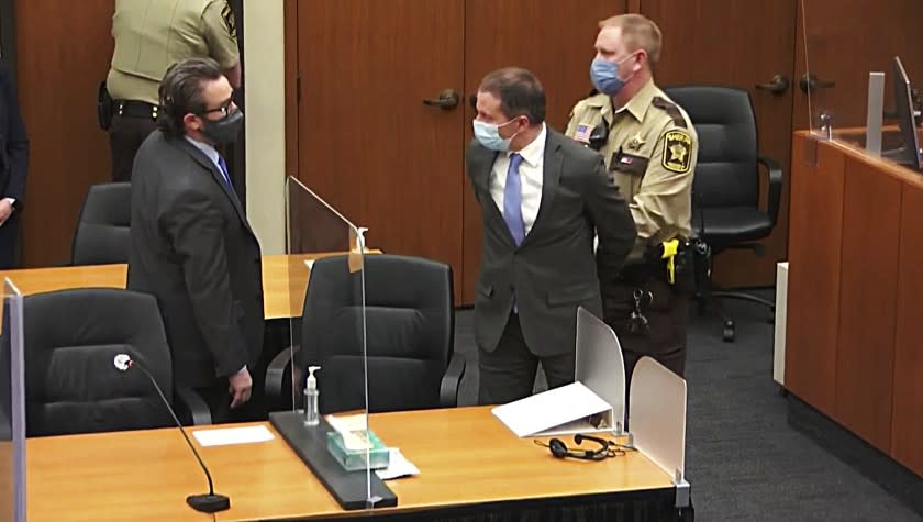 In this image from video, former Minneapolis police Officer Derek Chauvin, center, is taken into custody as his attorney, Eric Nelson, left, looks on, after the verdicts were read at Chauvin's trial for the 2020 death of George Floyd, Tuesday, April 20, 2021, at the Hennepin County Courthouse in Minneapolis, Minn. (Court TV via AP, Pool)