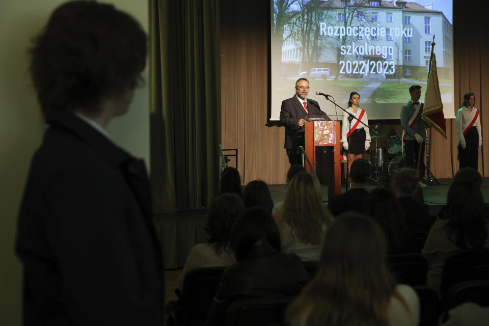 Andrzej Wyrozembski, a school principal at the Limanowski High School, gives an opening speech at the beginning of a new school year in Warsaw, Poland, Thursday, Sept. 1, 2022. The public schools in Poland are facing a shortage of teachers, a problem that is growing increasingly serious each year as people leave the profession over low wages and policies of a government which they fear does not value them. A teachers union and teachers say the situation threatens the education of the country's youth, though the government insists that they are exaggerating the scale of the problem. (AP Photo/Michal Dyjuk)