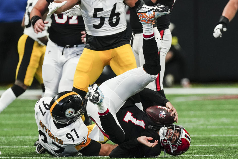 Atlanta Falcons quarterback Marcus Mariota (1) is sacked by Pittsburgh Steelers defensive tackle Cameron Heyward (97) during the first half of an NFL football game, Sunday, Dec. 4, 2022, in Atlanta. (AP Photo/John Bazemore)