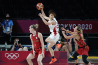 Japan's Nanako Todo, center, catches a pass over Belgium's Kim Mestdagh, left, and Julie Allemand, right, during a women's basketball quarterfinal round game at the 2020 Summer Olympics, Wednesday, Aug. 4, 2021, in Saitama, Japan. (AP Photo/Charlie Neibergall)