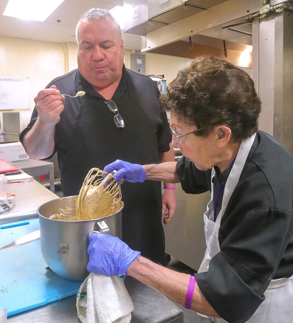 Chef Beau Schmidt samples the filling that his mother, Jerry Schmidt, made for her special peanut butter pie in the kitchen at Beau's Grille in the Akron-Fairlawn Hilton on May 2.
