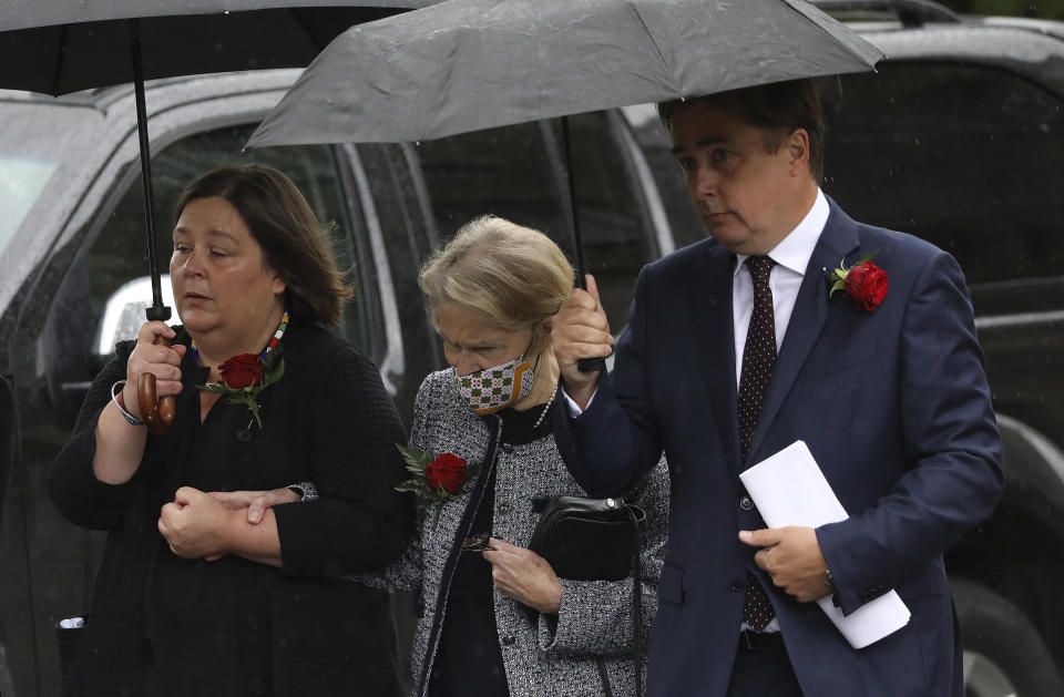 Patricia Hume, center, with her with her son John Hume and daughter Mo arrive to attend her husband John Hume the former Northern Ireland lawmaker and Nobel Peace Prize winner, funeral Mass at St Eugene's Cathedral in Londonderry, Northern Ireland, Wednesday, Aug. 5, 2020. Hume was co-recipient of the 1998 Nobel Peace Prize with fellow Northern Ireland lawmaker David Trimble, for his work in the Peace Process in Northern Ireland. (AP Photo/Peter Morrison)