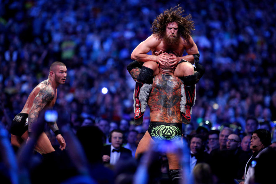 Randy Orton, left, Daniel Bryan, top, and Batista compete during Wrestlemania XXX at the Mercedes-Benz Super Dome in New Orleans on Sunday, April 6, 2014. (Jonathan Bachman/AP Images for WWE)