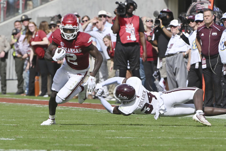 Arkansas wide receiver Andrew Armstrong (2) tries to shake Mississippi State defensive back Brice Pollock (34) during the second half of an NCAA college football game Saturday, Oct. 21, 2023, in Fayetteville, Ark. (AP Photo/Michael Woods)