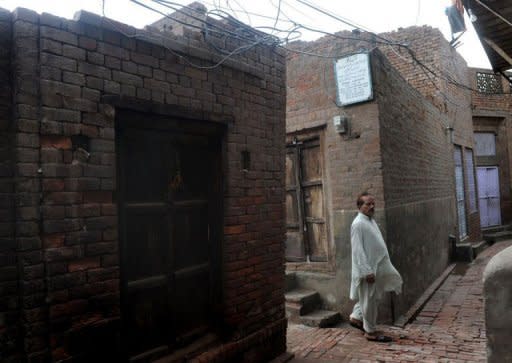 A local resident walk past the former home and birth place of Professor Abdus Salam, Pakistan's only Nobel laureate, in Jhang. The two-room bungalow today stands empty, testament to the indifference, bigotry and prejudice surrounding the country's greatest scientist