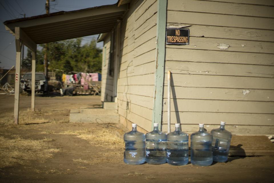 An allotment of drinking water is given to residents of Tooleville, Calif.