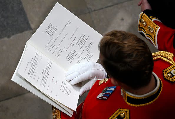 LONDON, ENGLAND - SEPTEMBER 19: A guest reads the order of service during the State Funeral of Queen Elizabeth II at Westminster Abbey on September 19, 2022 in London, England. Elizabeth Alexandra Mary Windsor was born in Bruton Street, Mayfair, London on 21 April 1926. She married Prince Philip in 1947 and ascended the throne of the United Kingdom and Commonwealth on 6 February 1952 after the death of her Father, King George VI. Queen Elizabeth II died at Balmoral Castle in Scotland on September 8, 2022, and is succeeded by her eldest son, King Charles III.  (Photo by Gareth Cattermole/Getty Images)