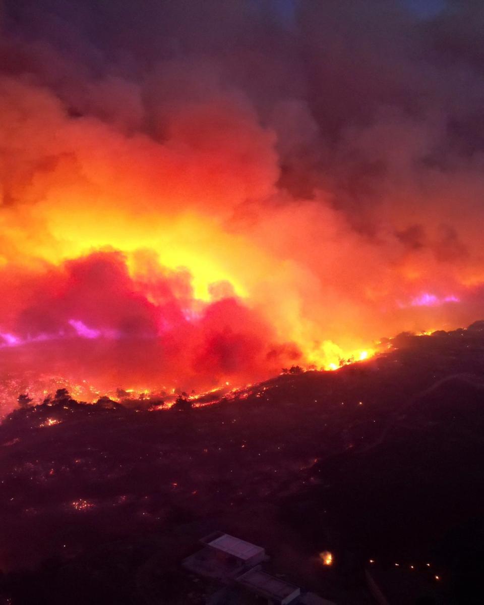 Smoke rises from a wildfire on the island of Rhodes (TED G. BAILOS via REUTERS)