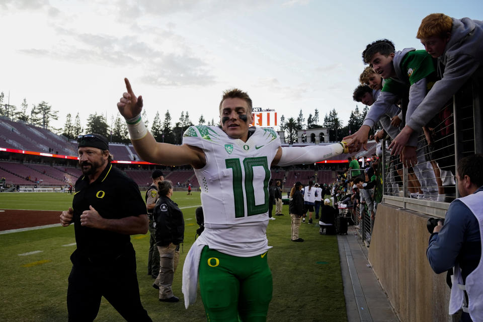 Oregon quarterback Bo Nix (10) is greeted by fans as he exits the field after the team's victory over Stanford in an NCAA college football game, Saturday, Sept. 30, 2023, in Stanford, Calif. (AP Photo/Godofredo A. Vásquez)