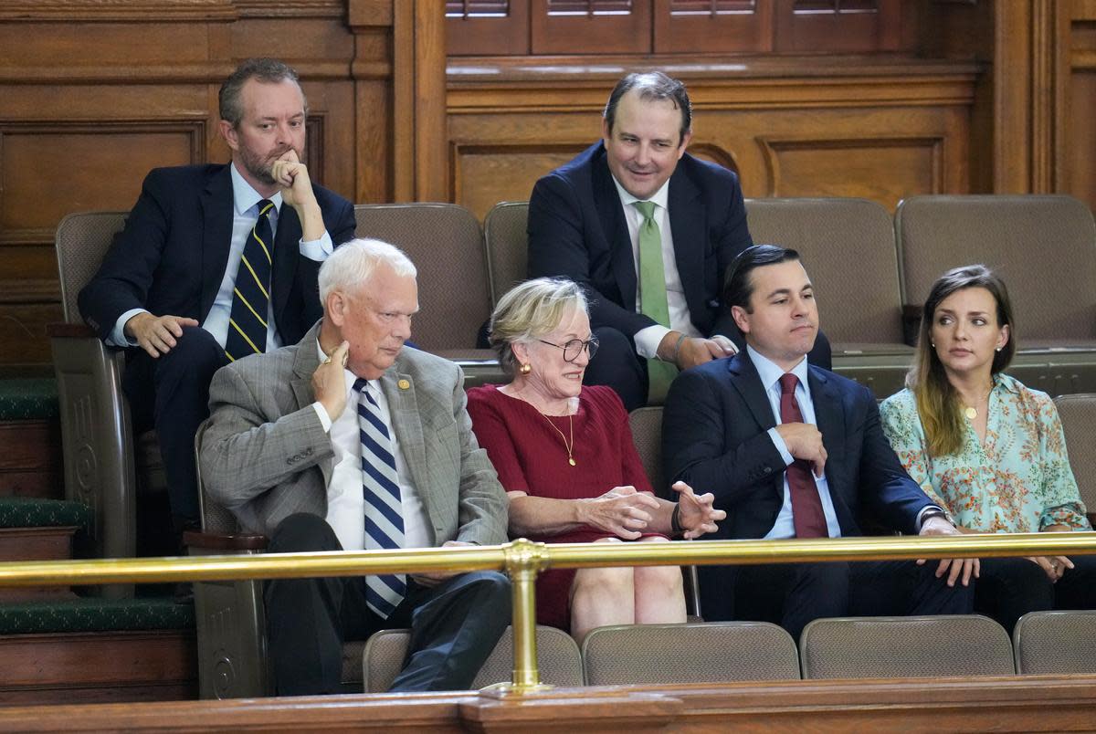 Several of the whistleblowers from the attorney general's office sit in the gallery anticipating the verdicts at the Ken Paxton impeachment trial in the Texas Senate on Sept. 16, 2023. From left, front row: David Maxwell, Margaret Moore, Ryan Vassar, unknown; back row: Blake Brickman and T.J. Turner.