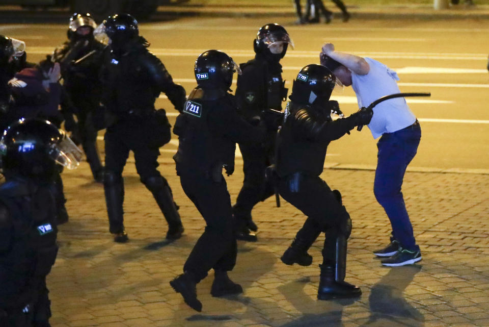 FILE - In this file photo taken on Monday, Aug. 10, 2020, police clash with a protester following presidential elections in Minsk, Belarus, that demonstrators have dismissed as rigged. Hundreds of people released from custody after a violent crackdown on protests in Belarus are sharing their accounts of harsh treatment at the hands of police. (AP Photo/Sergei Grits, File)