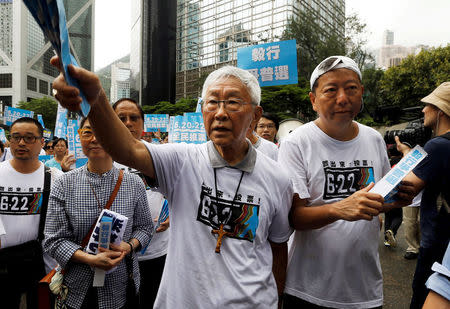 Former head of the Catholic Church in Hong Kong Cardinal Joseph Zen (C) takes part in a kick-off ceremony to urge people to vote in an unofficial referendum June 20, 2014. REUTERS/Bobby Yip/File Photo