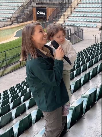 <p>bindisueirwin/Instagram</p> Bindi Irwin's daughter Grace says a few words on the microphone during the meeting alongside her mother.