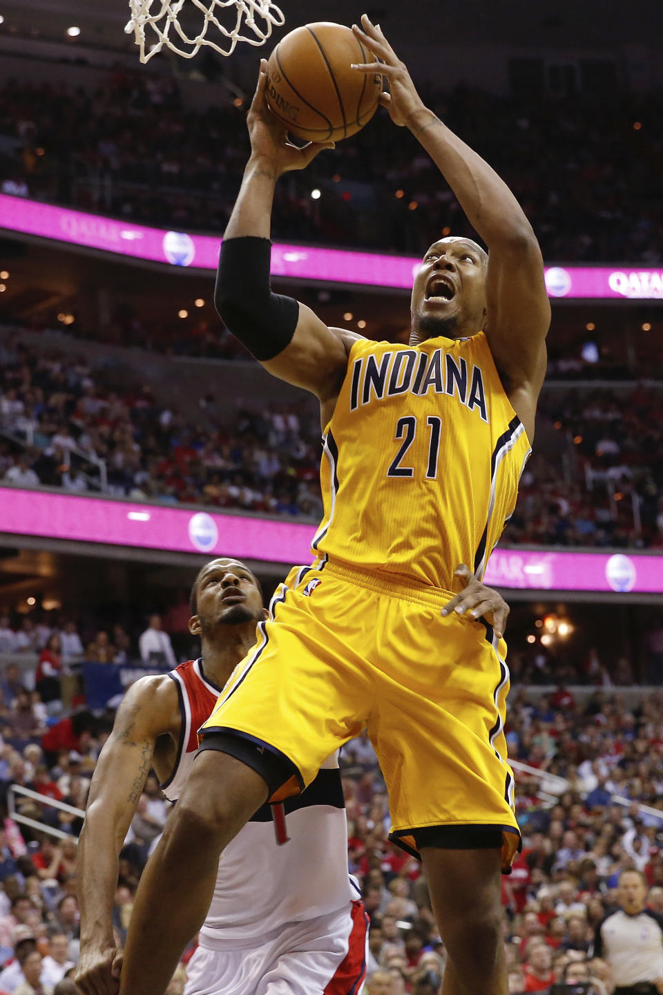 Indiana Pacers forward David West (21) shoots under pressure from Washington Wizards forward Trevor Ariza (1) during the second half of Game 4 of an Eastern Conference semifinal NBA basketball playoff game in Washington, Sunday, May 11, 2014. (AP Photo/Alex Brandon)