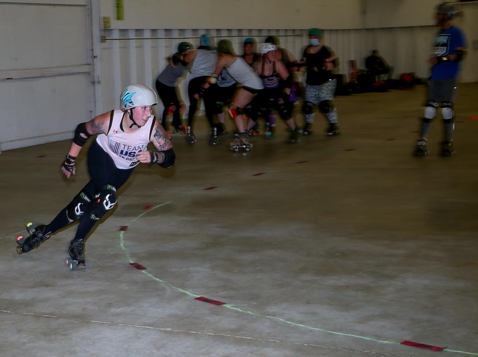 West Sound Roller Derby’s Kaylee Jankowski, who goes by the name Mad Medic on the track, skates the part of the jammer and cruises around the track during practice in the Sheep Barn at the Kitsap County Fairgrounds on Monday.