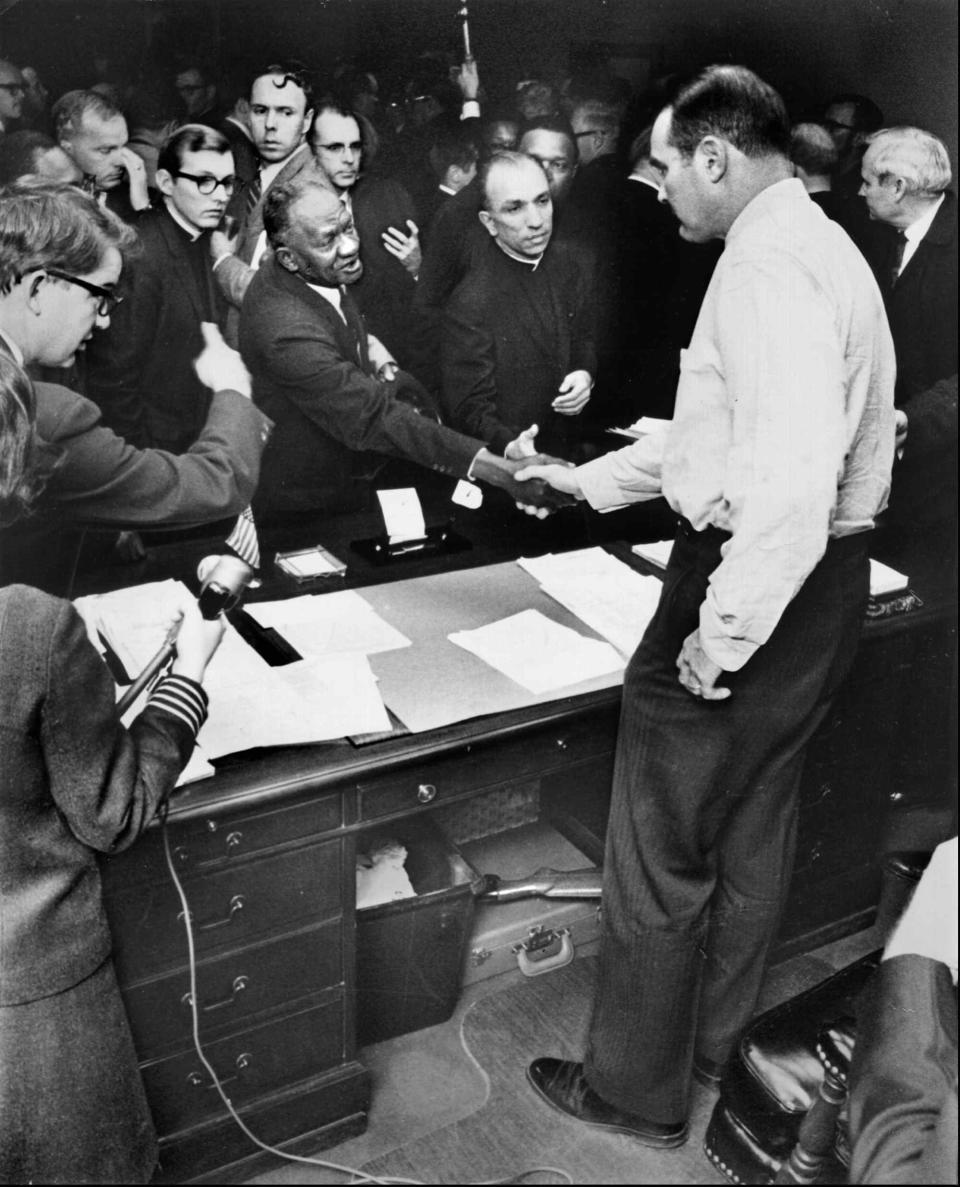 One day after the assassination of Dr. Martin Luther King Jr., Memphis Mayor Henry Loeb - a shotgun beneath his desk - greeted about 300 black and white ministers in his office Friday, April 5, 1968, shaking hands with Rev. Joseph P. Toney while Father Nicholas L. Vieron (behind the clasped hands) looked on. The ministers - who represented congregations in wealthy East Memphis and the impoverished inner city - were impressed with Loeb's cordiality in the face of such a potentially uncomfortable confrontation. The ministers were calling for an end to the sanitation strike and union recognition for the workers. But Loeb gave no indication he was willing to compromise with the strikers. "I know this might sound corny, but it happened. I knelt before Jim Jordan (pastor of First Baptist Church - Beale Street) and said, 'On behalf of we who represent the white race, I make a gesture of apology and ask for forgiveness,'" said Father Vieron in a 1992 interview.  At the time of his death, Dr. King was on his third visit to Memphis in support of striking sanitation workers. 