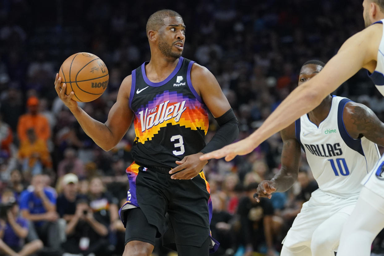 Phoenix Suns guard Chris Paul (3) looks to pass against the Dallas Mavericks during the first half of Game 7 of an NBA basketball Western Conference playoff semifinal, Sunday, May 15, 2022, in Phoenix. (AP Photo/Matt York)