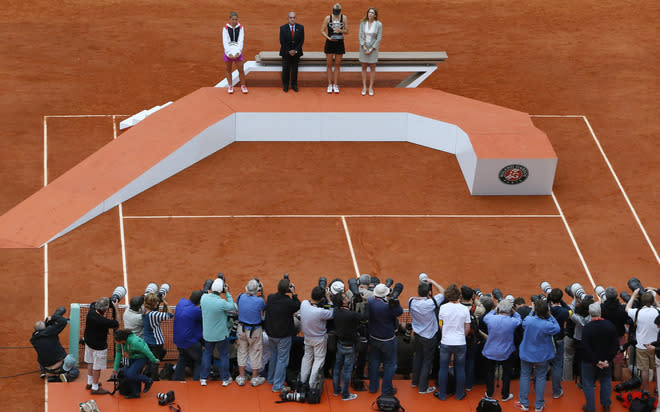 Russia's Maria Sharapova (2ndR) and Italy's Sarah Errani (L) pose with her trophies near former tennis champion Monica Seles (R) and President of French Tennis Federation Jean Gachassin (L) on the podium after their Women's Singles final tennis match of the French Open tennis tournament at the Roland Garros stadium, on June 9, 2012 in Paris. Sharapova won the final. AFP PHOTO / KENZO TRIBOUILLARDKENZO TRIBOUILLARD/AFP/GettyImages