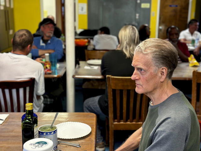 Scott Snyder sits for dinner at an emergency shelter for homeless men run by St. Elizabeth Shelters in Santa Fe, N.M., on Monday, May 22, 2023. A new tally of the homeless population in New Mexico shows an abrupt jump in the number of people living without permanent housing or with no shelter at all amid surging prices for rent. (AP Photo/Morgan Lee)