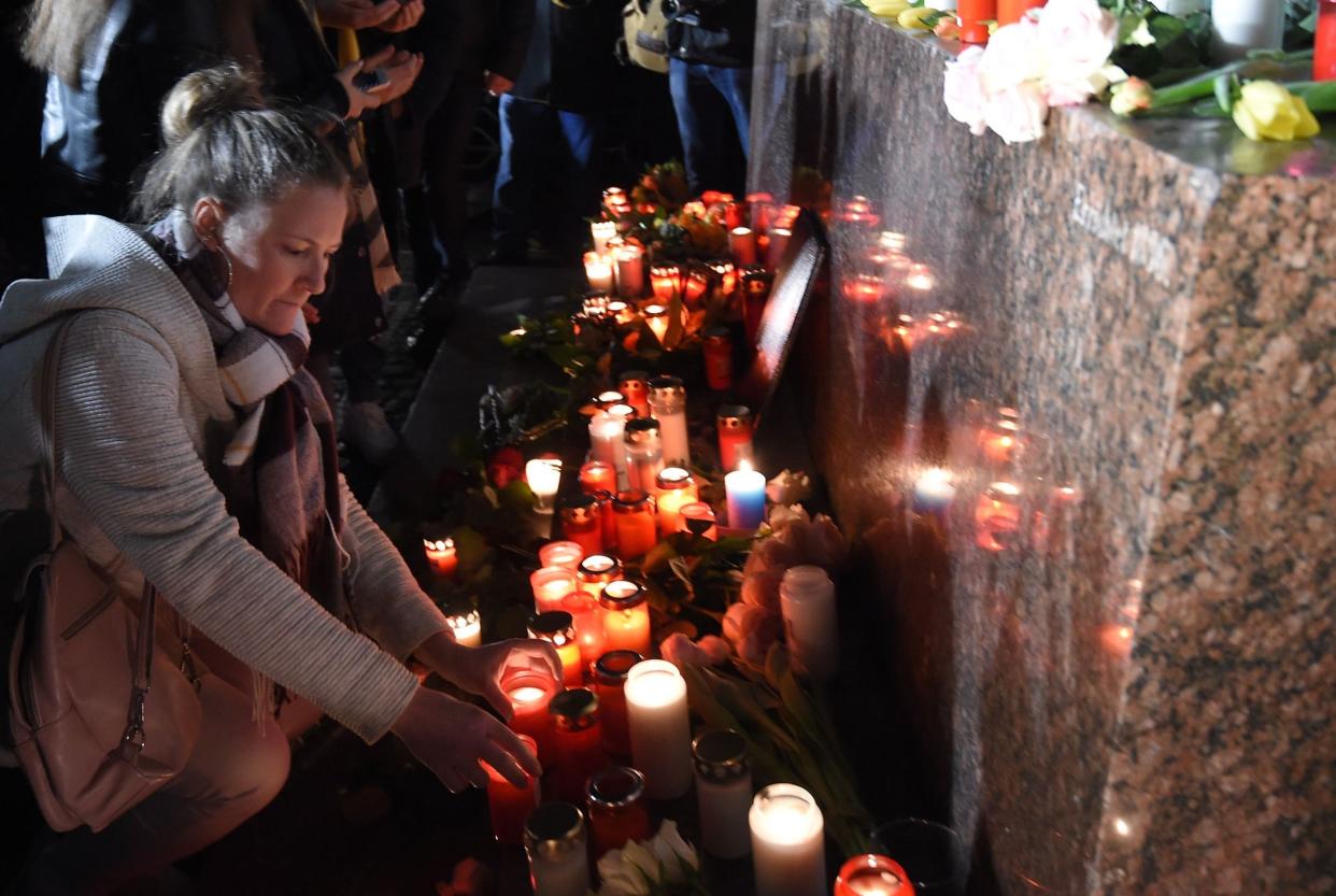 People set up candles during a vigil in Hanau: AFP/Getty