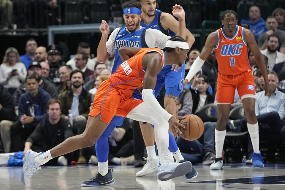 Oklahoma City Thunder guard Shai Gilgeous-Alexander (2) drives against Dallas Mavericks guard Seth Curry during the first half of an NBA basketball game in Dallas, Saturday, Dec. 2, 2023. (AP Photo/LM Otero)