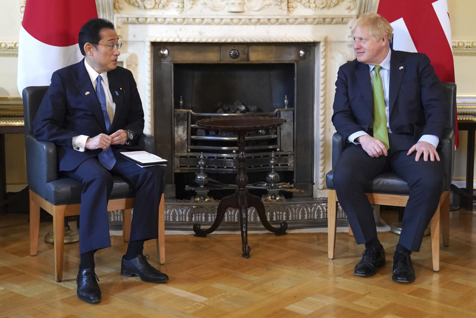 Britain's Prime Minister Boris Johnson, right, speaks to Japan's Prime Minister Fumio Kishida, during their meeting, at 10 Downing Street, in London, Thursday, May 5, 2022. The leaders of Britain and Japan met in London to announce a new defense agreement against the backdrop of the war in Ukraine. (Stefan Rousseau//Pool Photo via AP)