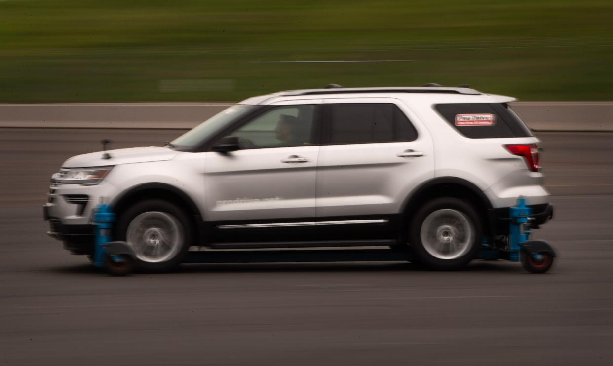 A driver gets a feel for driving on snow and ice using a specially equipped vehicle at the Pro Drive Racing School in Portland.