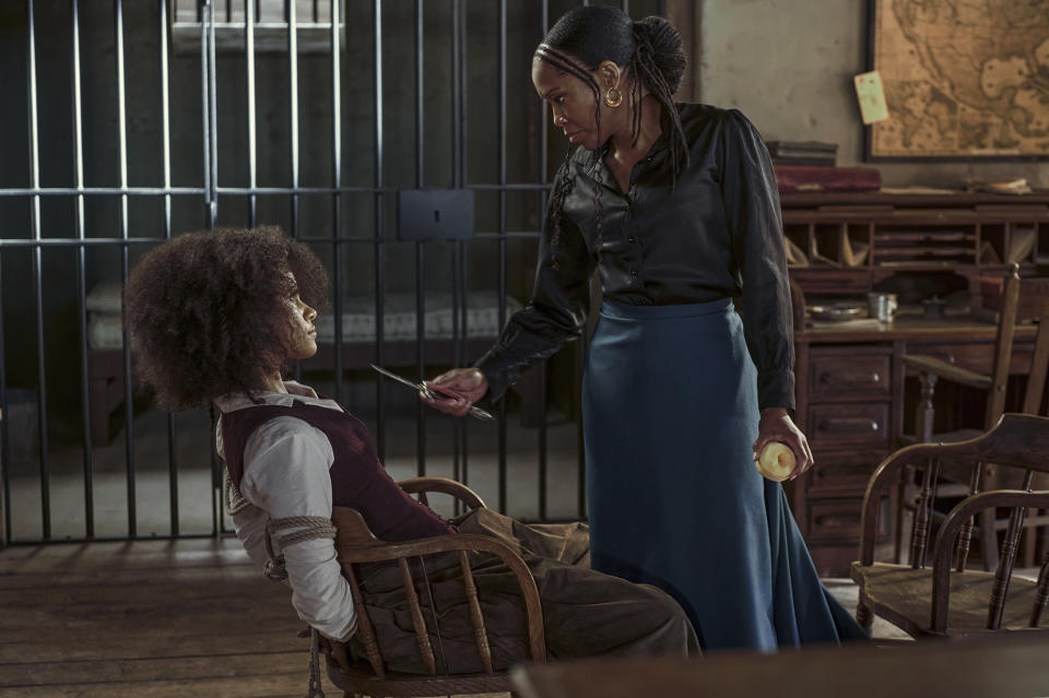 This image released by Netflix shows Zazie Beetz, left, and Regina King in a scene from "The Harder They Fall." (David Lee via AP)