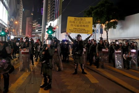 A riot police officer holds a sign in Causeway Bay station in Hong Kong