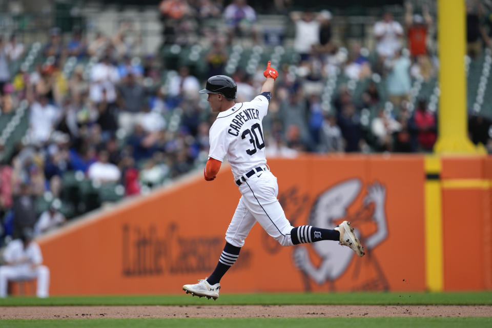 Detroit Tigers' Kerry Carpenter celebrates as he rounds second base on his grand slam against the Chicago Cubs in the sixth inning of a baseball game, Wednesday, Aug. 23, 2023, in Detroit. (AP Photo/Paul Sancya)