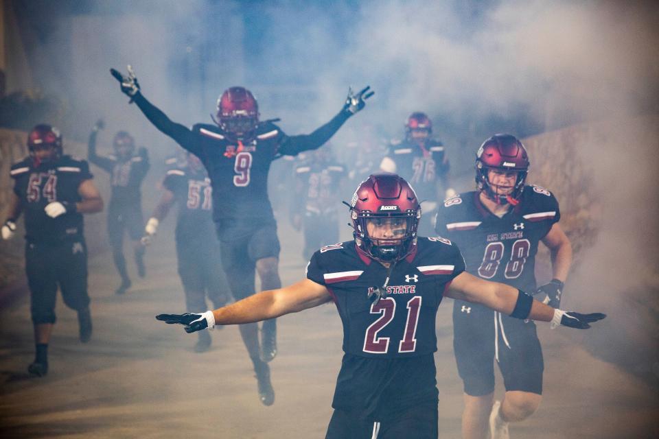 NMSU football players run onto the field during the New Mexico State University game on Saturday, Aug. 27, 2022, at the Aggie Memorial Stadium. 