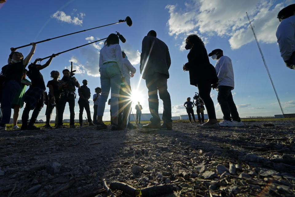 EPA Administrator Michael Regan talks with Sharon Lavigne and other members of the group Rise St. James, as he tours a neighborhood next to the Nu Star Energy oil storage tanks, in St. James Parish, La., Tuesday, Nov. 16, 2021. The EPA is investigating whether Louisiana regulators are discriminating against Black residents by failing to control air pollution in parishes packed with refineries and petrochemical plants, a region some call cancer alley. (AP Photo/Gerald Herbert)