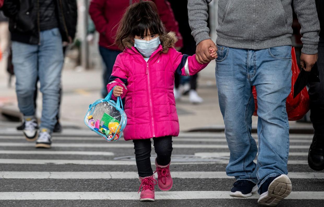 <span class="caption">A girl wearing a mask walks down a street in the Corona neighborhood of Queens on April 14, 2020 in New York City. </span> <span class="attribution"><a class="link " href="https://www.gettyimages.com/detail/news-photo/girl-wearing-a-mask-walks-down-a-street-in-the-corona-news-photo/1209895797?adppopup=true" rel="nofollow noopener" target="_blank" data-ylk="slk:Johannes Eisele/AFP via Getty Images;elm:context_link;itc:0;sec:content-canvas">Johannes Eisele/AFP via Getty Images</a></span>