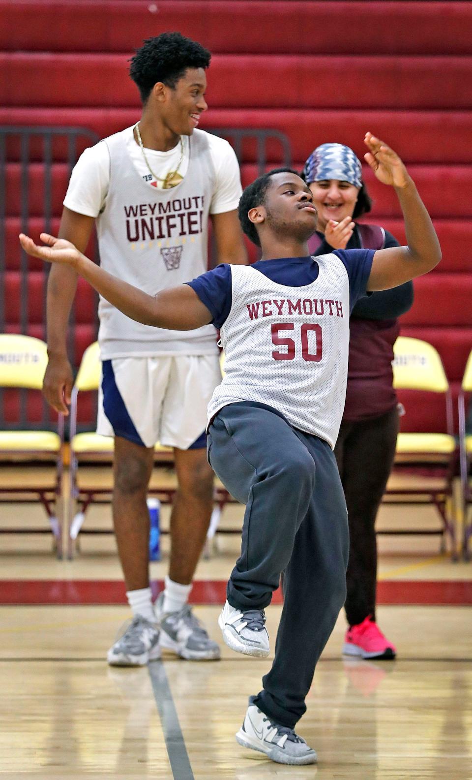 Dancing up a storm: Javaris Jackson dances at half time. Behind him is Edric Louissaint, a basketball forward, and bench coach/student Batoul Alshimrpy on Monday, Oct. 3, 2022.