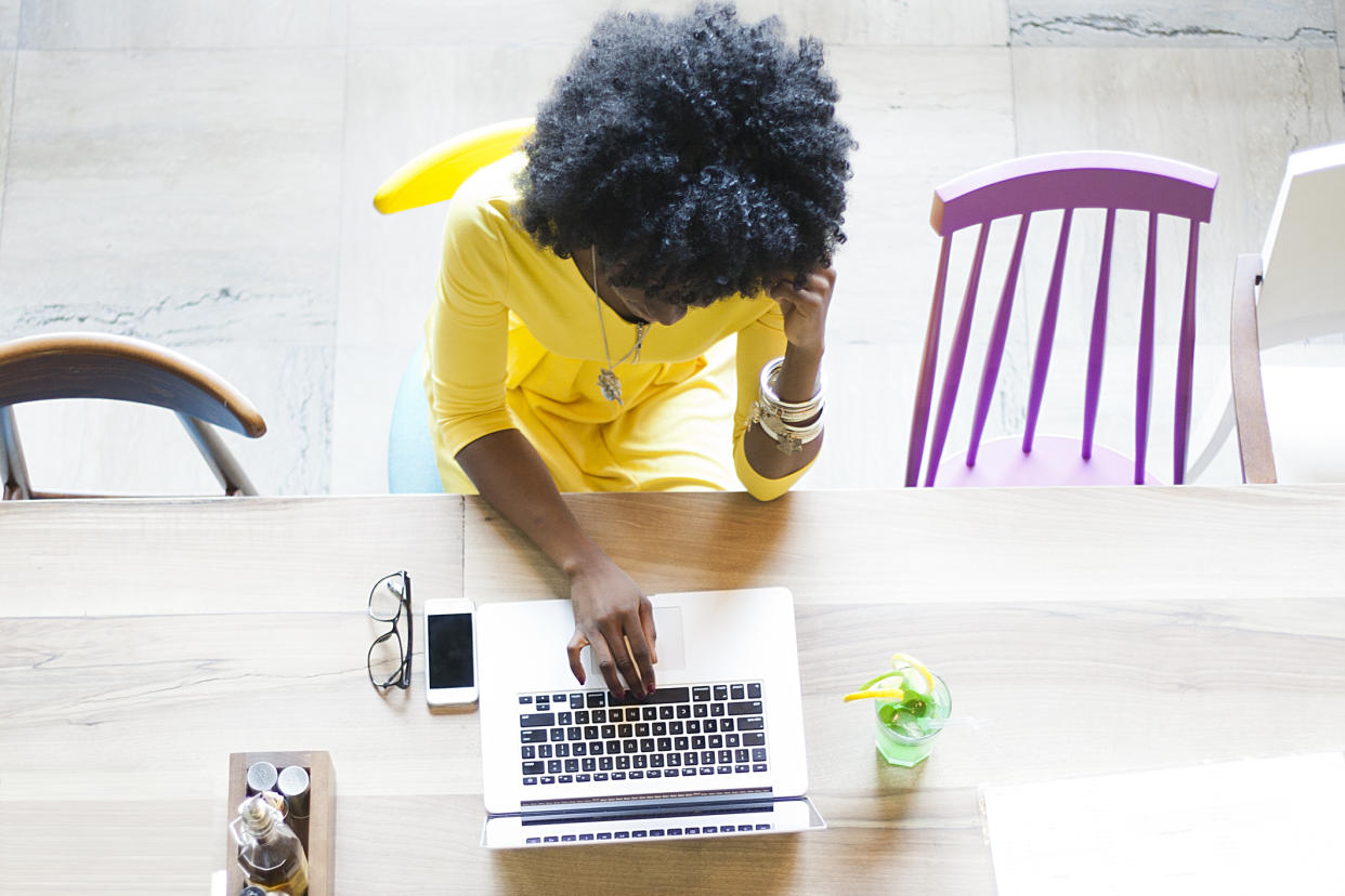 Woman working at cafe (Photo: Getty Images)