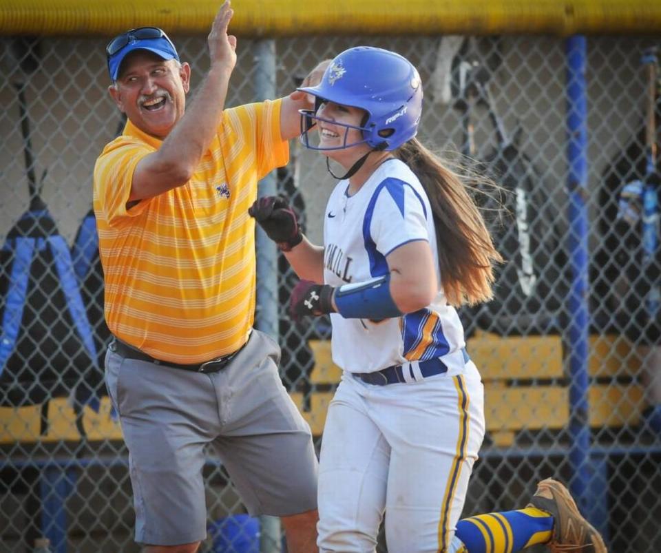 Herald file 2015: Fort Mill’s Lauren Collie and coach Chuck Stegall celebrate Collie’s sixth inning two-run homer against Dutch Fork.
