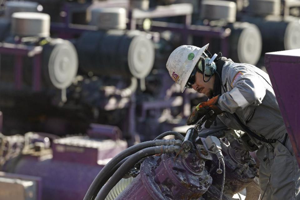 In this March 25, 2014 photo, a worker oils a pump during a hydraulic fracturing operation at an Encana Corp. well pad near Mead, Colo. The first experimental use of hydraulic fracturing was in 1947, and more than 1 million U.S. oil and gas wells have been fracked since, according to the American Petroleum Institute. The National Petroleum Council estimates that up to 80 percent of natural gas wells drilled in the next decade will require hydraulic fracturing. (AP Photo/Brennan Linsley)