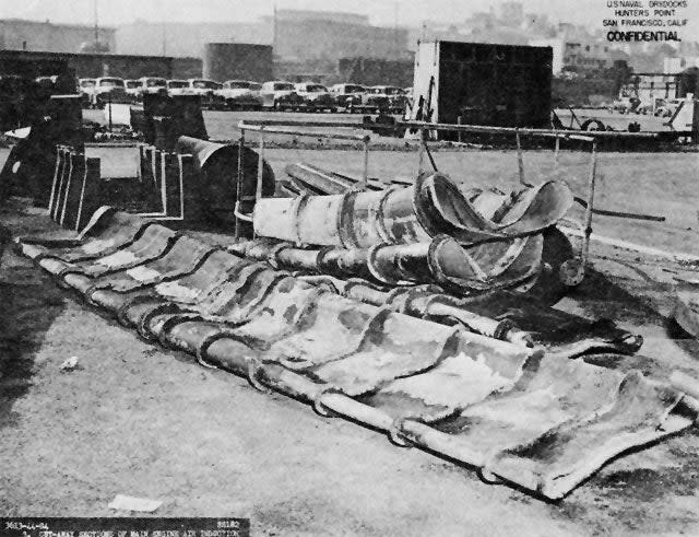 Collapsed engine air induction piping after removal from ship. <em>U.S. Navy</em>