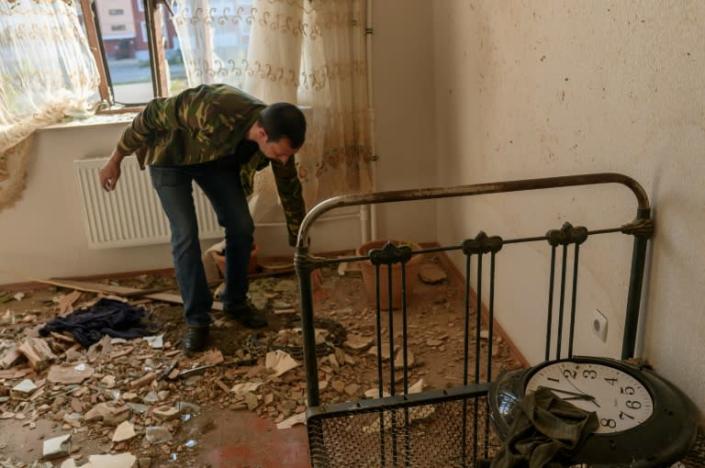 Movsumov Qowkar views the damage to his home inflicted during fighting over the breakaway region of Nagorno-Karabakh